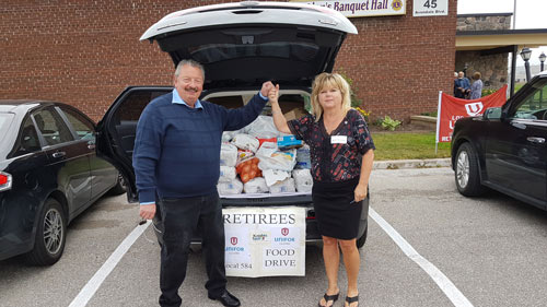 President of Unifor Local 584 Barb Morrison (Right) and Chris Wilski Unifor Local 584 Retirees Chair congratulating each other on our successful accomplishment.