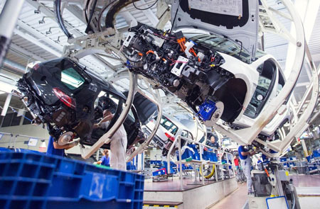 Volkswagen GTE Golf hybrid automobiles hang as they move along the assembly line inside the Volkswagen AG (VW) factory in Wolfsburg, Germany, on Friday, May 20, 2016. 
